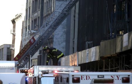 A New York City firefighter works on the scene where a building undergoing demolition work partially collapsed, in New York October 30, 2015. REUTERS/Brendan McDermid