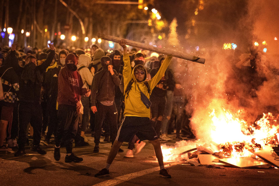 Protestors make barricades in the street during clashes with police in Barcelona, Spain, Wednesday, Oct. 16, 2019. Spain's government said Wednesday it would do whatever it takes to stamp out violence in Catalonia, where clashes between regional independence supporters and police have injured more than 200 people in two days. (AP Photo/Emilio Morenatti)