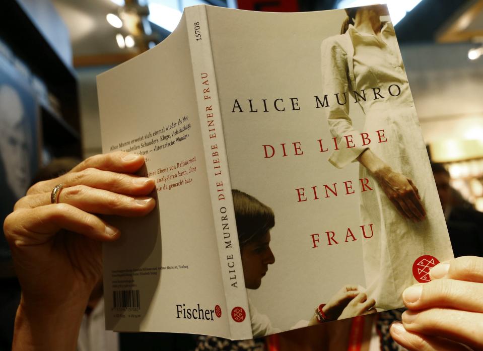 An employee of publisher S.Fischer holds up book by Nobel Prize in Literature winner Munro during book fair in Frankfurt