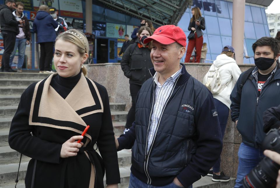 In this picture taken on Wednesday, May 26, 2020, Valery Tsepkalo, a potential candidate in the upcoming presidential election, smiles as his wife Veronica looks on in Minsk, Belarus. The central elections commission in Belarus has rejected a top challenger's bid to run against authoritarian President Alexander Lukashenko in this summer's election. Tsepkalo, a former ambassador to the United States and a founder of a successful high-technology park, submitted 160,000 signatures on petitions to get on the ballot for the Aug. 9 election, but the commission said only 75,000 were valid less than the 100,000 needed. (AP Photo/Sergei Grits)