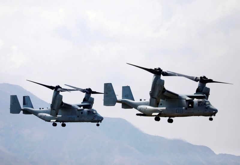 FILE PHOTO: Two Osprey helicopters fly during amphibious landing exercises during U.S.-Philippines war games promoting bilateral ties in Zambales province, Philippines