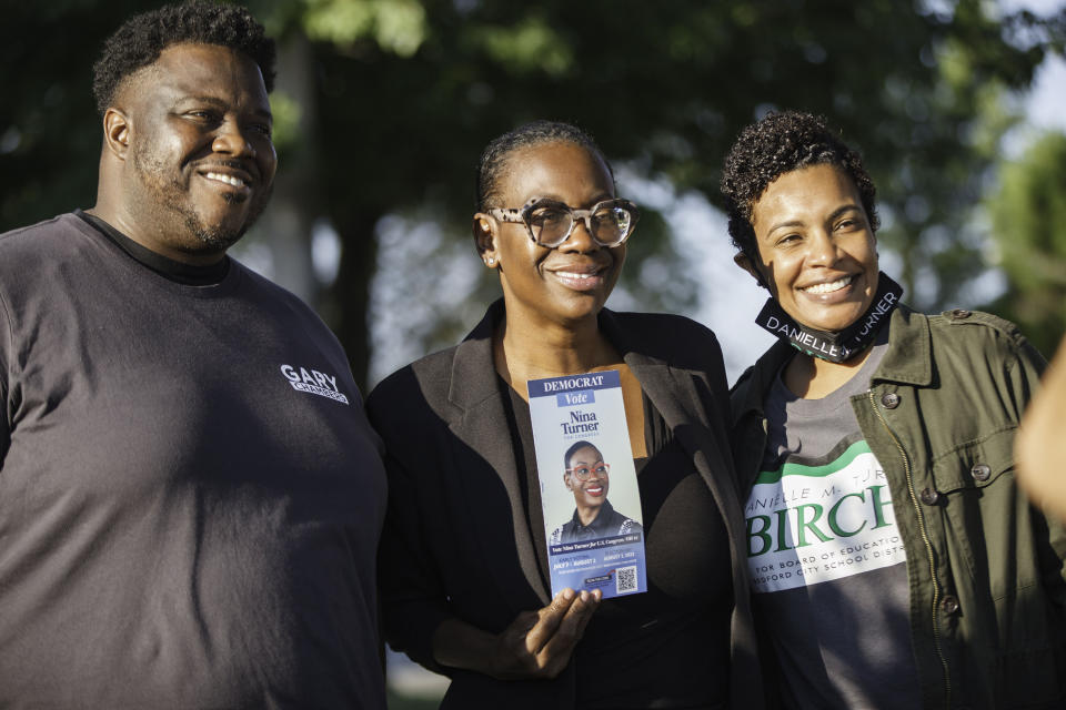 Gary Chambers poses with progressive politician Nina Turner and a woman wearing a shirt that reads: Danielle M. Turner-Birch for Board of Education for Bedford.