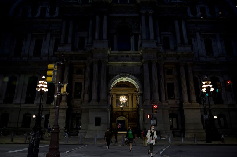 Philadelphia City Hall, an early voting location for the upcoming presidential election, is illuminated at night in Philadelphia, Pennsylvania