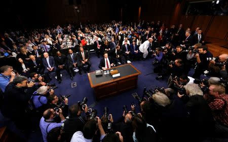 FILE PHOTO: Former FBI Director James Comey prepares to testify before a Senate Intelligence Committee hearing on "Russian Federation Efforts to Interfere in the 2016 U.S. Elections" on Capitol Hill in Washington, U.S. June 8, 2017. REUTERS/Jim Bourg/File Photo