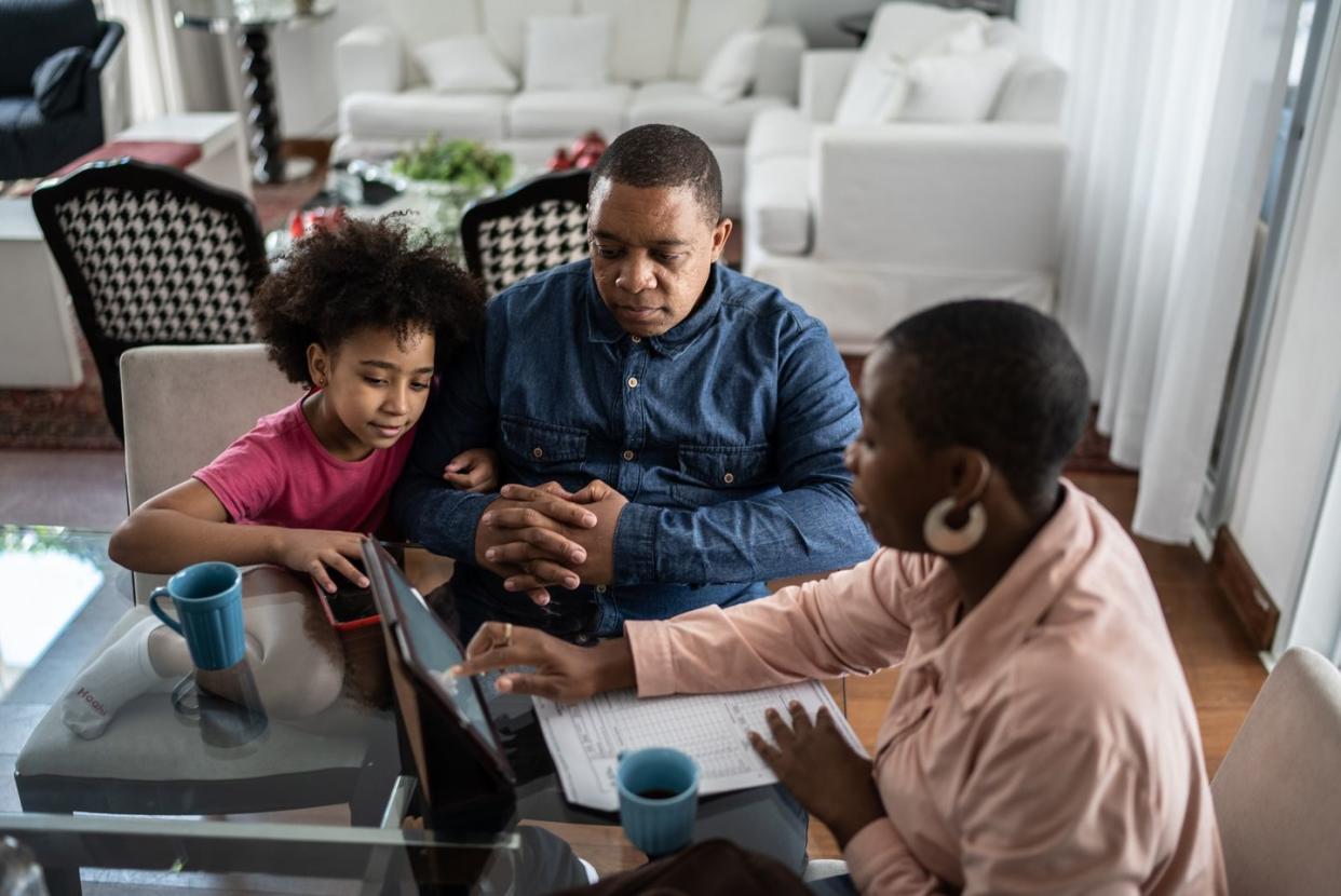 professional consultant talking to customer and his daughter during home visit