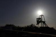 FILE - A tower, used by a rescue team to enter the Pinebete mine where miners are trapped, is silhouetted against an afternoon sky in Sabinas, Coahuila state, Mexico, Aug. 4, 2022. Fifteen men were working inside the mines, about 70 miles southwest of Eagle Pass, Texas on Aug. 3., when a wall of water from an abandoned mine next door filled the single shaft 40 meters (yards) deep. Five miners managed to escape as the mine flooded, but there has been no contact with the rest. (AP Photo/Alfredo Lara, File)