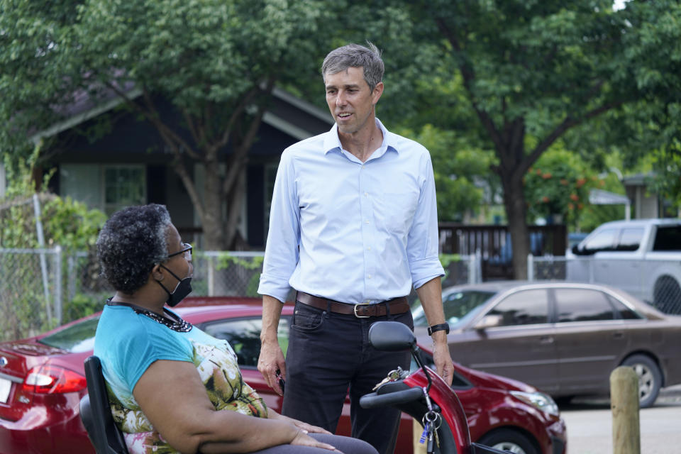 Beto O'Rourke, right, speaks with Stephanie Hanson before a canvassing drive by the Texas Organizing Project in West Dallas Wednesday, June 9, 2021. The former congressman and senatorial candidate is driving an effort to gather voter support to stop Texas' SB7 voting legislation. As politicians from Austin to Washington battle over how to run elections, many voters are disconnected from the fight. While both sides have a passionate base of voters intensely dialed in on the issue, a disengaged middle is baffled at the attention. (AP Photo/LM Otero)