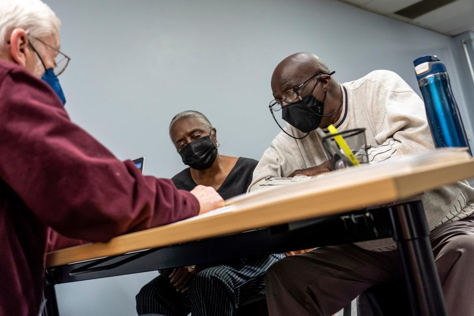 Maud Robinson, right, of Detroit, and his wife, Iuta Robinson, listen to volunteer tax preparer Jon Oatley as he goes over their refund with them at the Accounting Aid Society Northwest Financial Hub in Detroit on March 16, 2023. Households with income below $60,000 can qualify for free tax preparation unless they include things such as including rental income; business use of the home, or someone who is self-employed with inventory or costs of goods sold.