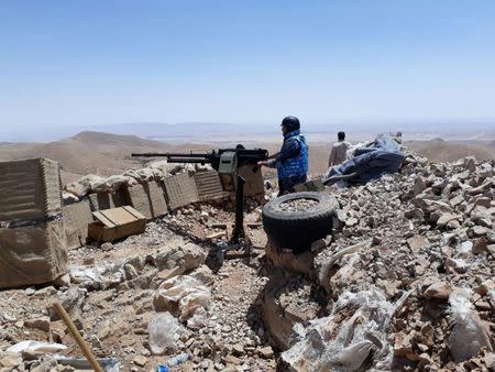Fighters from the Syrian army units and Hezbollah are seen on the western mountains of Qalamoun, near Damascus, in this handout picture provided by SANA on July 23, 2017, Syria. SANA/Handout via REUTERS