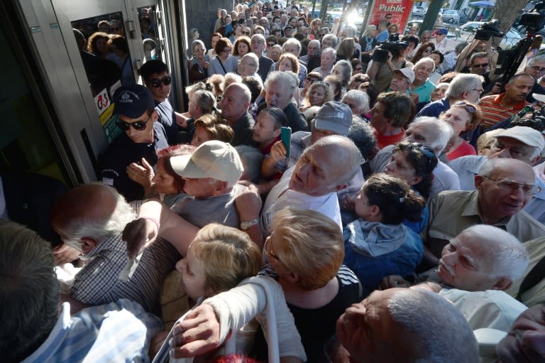 Pensioners queue outside a National Bank branch, as banks only opened for the retired to allow them to cash up to 120 euros in Athens on July 1, 2015