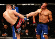 Cain Velasquez lands a kick to the face of Junior dos Santos during their heavyweight title fight at UFC 155. (Getty)