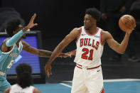 Chicago Bulls forward Thaddeus Young (21) looks to pass the ball as Charlotte Hornets forward Jalen McDaniels defends during the first quarter of an NBA basketball game in Charlotte, N.C., Thursday, May 6, 2021. (AP Photo/Nell Redmond)