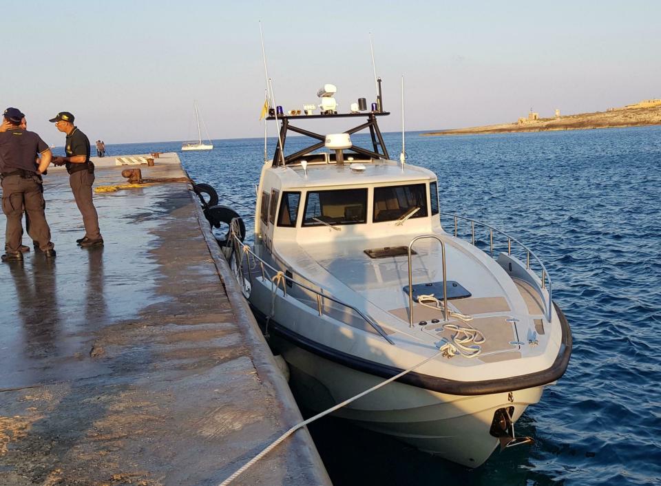 An Italian border police motorboat is moored at Lampedusa island's harbor, Italy, after being hit by the Dutch-flagged Sea-Watch 3 ship early Saturday, June 29, 2019. Forty migrants have disembarked on a tiny Italian island after the captain of the German aid ship which rescued them docked without permission. Sea-Watch 3 rammed an Italian border police motorboat as it steered toward the pier on Lampedusa. Italian Interior Minister branded the captain, who was taken into custody, as an "outlaw" who put the lives of the police at risk. (Elio Desiderio/ANSA via AP)