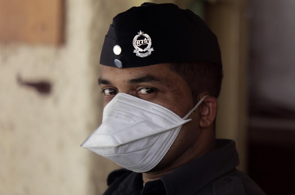 A security officer wears a mask outside a special ward set aside for possible COVID-19 patients, in Mumbai, India, Thursday, March 5, 2020. A new virus first detected in China has infected more than 90,000 people globally and caused over 3,100 deaths. The World Health Organization has named the illness COVID-19, referring to its origin late last year and the coronavirus that causes it. (AP Photo/Rajanish Kakade)