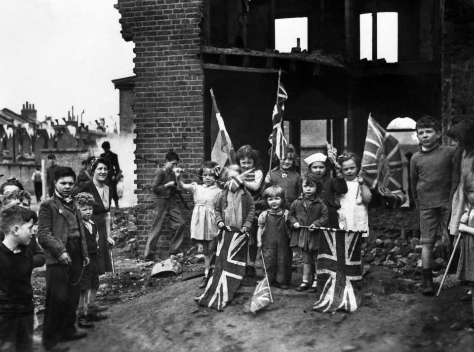 Young London residents celebrate VE-Day, (Victory-in-Europe Day) marking the end of the war in Europe, amidst the ruins of their home in Battersea.