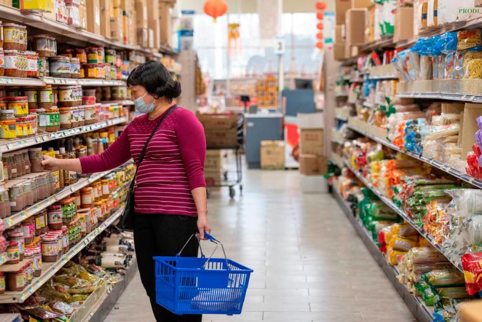 Shoppers browse the shelves at Lee’s Grocery in Biloxi on Monday, Jan. 24, 2022.