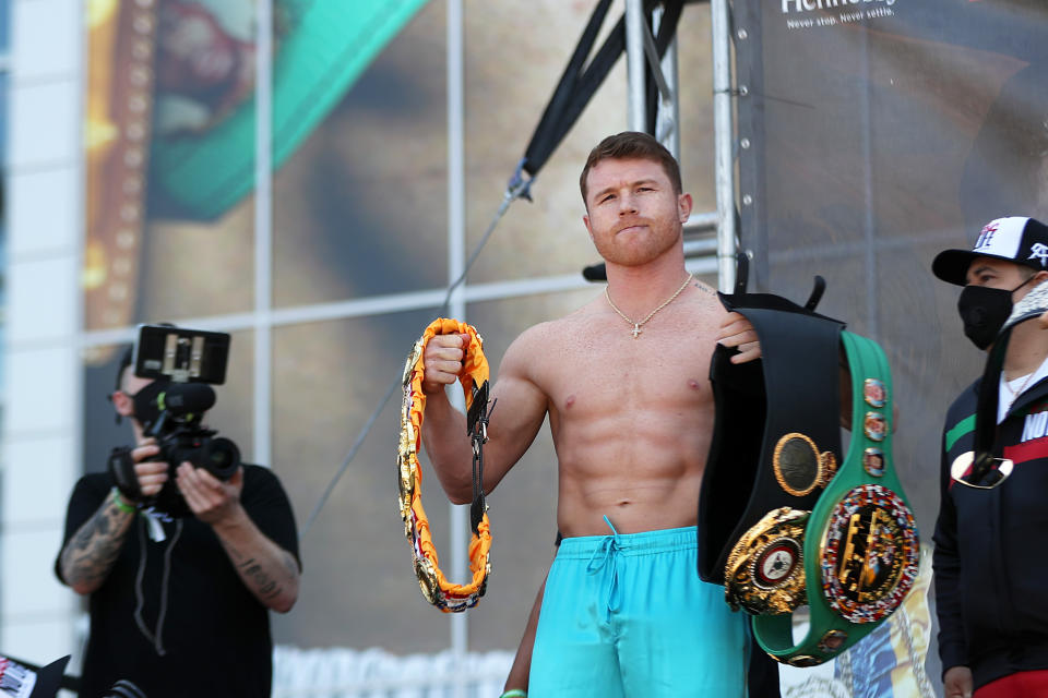 ARLINGTON, TX - MAY 07: Boxer Saul Canelo Alvarez poses for picture with his champion belts during the official Weigh-in at AT&T Stadium on May 7, 2021 in Arlington, Texas. (Photo by Omar Vega/Getty Images)