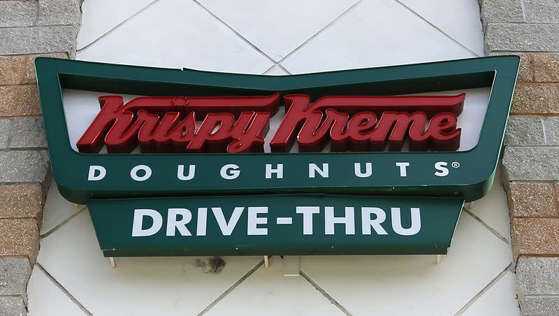 This photo taken Friday, Aug. 11, 2017, shows a Krispy Kreme Doughnuts sign in Miami.