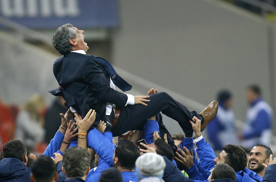 FILE - Fernando Santos, the coach of Greece is thrown into the air by his team at the end of the World Cup qualifying playoff second leg soccer match against Romania at the National Arena in Bucharest, Tuesday, Nov. 19, 2013. Greece drew the match 1-1 and qualified for Brazil 2014 4-2 on aggregate. Greece's Football Association said Thursday Feb. 27, 2014, that national coach Fernando Santos will step down following the World Cup in Brazil, after a successful four-year term on the job that saw the country rise to 12th place in the the FIFA world rankings. (AP Photo/Vadim Ghirda, File)