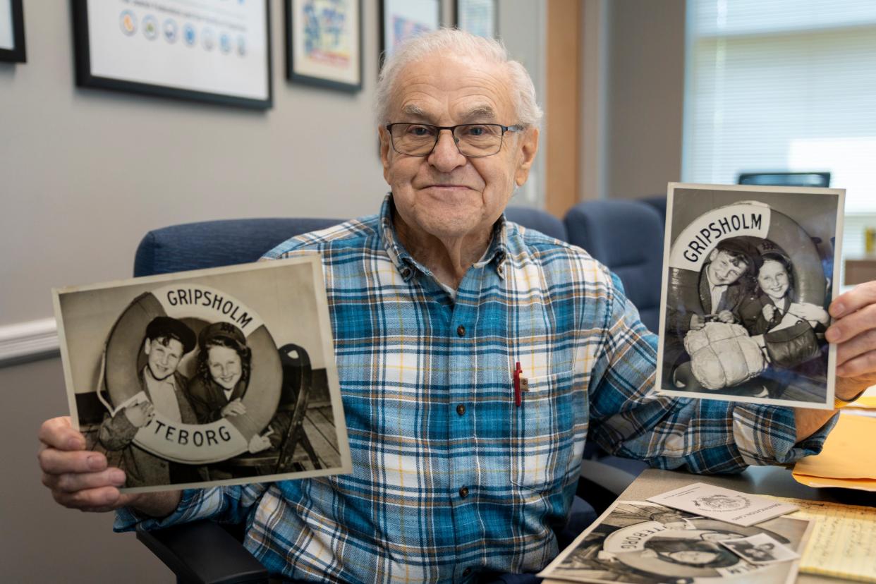 Holocaust survivor Fred Kurz holds up photos of himself and his sister, Doriane, from when they first arrived in the U.S., during an interview at the Jewish Community Center in Cherry Hill, N.J.