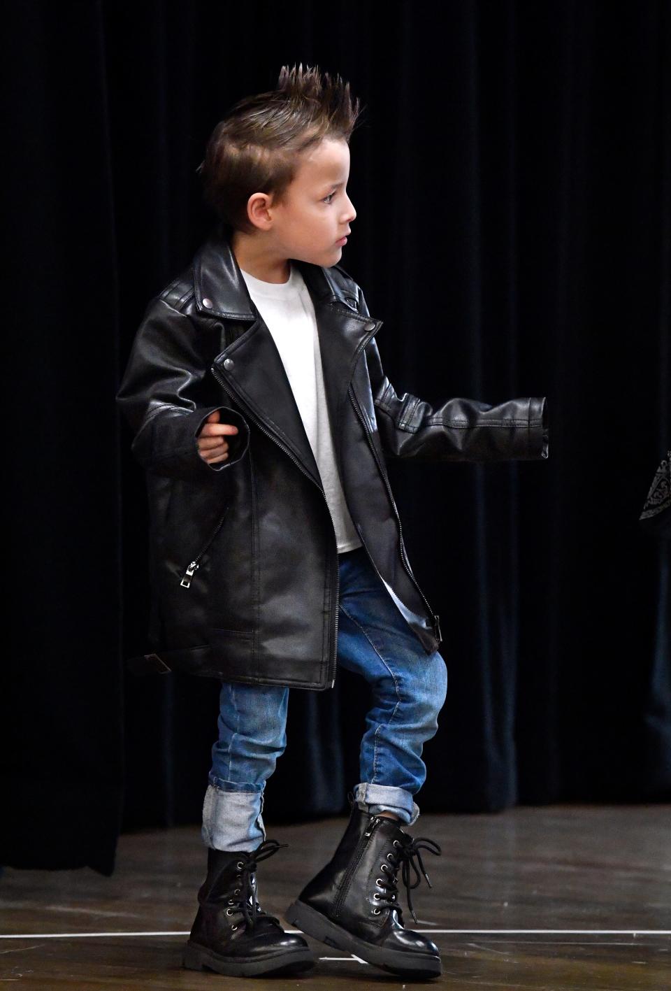 Austin Elementary first-grader David Carlton grooves to the beat as he waits in line for the Stroll at the school’s annual Fifties Day Friday Jan. 26, 2024.