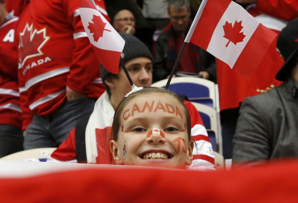 A Canadian fan watches during play between Canada and the Czech Republic during the first period of their IIHF World Junior Championship ice hockey game in Malmo, Sweden, December 28, 2013. REUTERS/Alexander Demianchuk (SWEDEN - Tags: SPORT ICE HOCKEY)