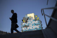 A man walks past a pro Europe street art painting in the European quarter in Brussels, Tuesday, July 23, 2019. Brexit champion Boris Johnson won the contest to lead Britain's governing Conservative Party on Tuesday and will become the country's next prime minister, tasked with fulfilling his promise to lead the U.K. out of the European Union. (AP Photo/Francisco Seco)