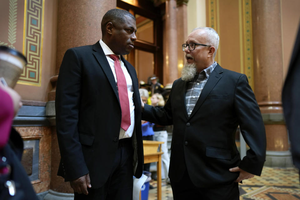 Rev. Mike Demastus, of Des Moines, Iowa, right, talks with State Rep. Eddie Andrews, left, Thursday, April 6, 2023, at the Statehouse in Des Moines, Iowa. (AP Photo/Charlie Neibergall)