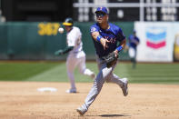 Texas Rangers first baseman Nathaniel Lowe throws to pitcher José Ureña, covering first base, for the out on Oakland Athletics' Seth Brown during the second inning of a baseball game Tuesday, May 7, 2024, in Oakland, Calif. (AP Photo/Godofredo A. Vásquez)