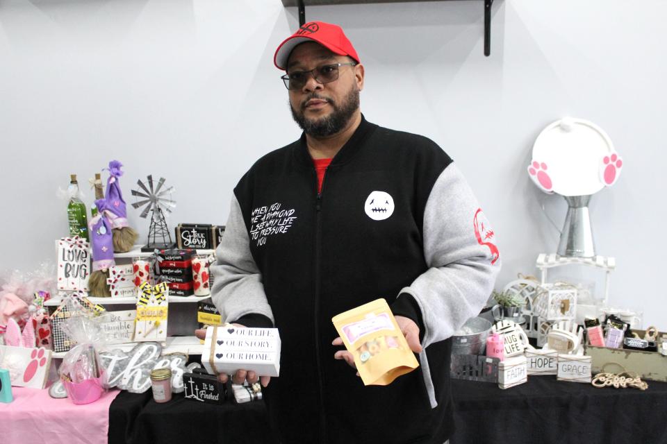 Monroe resident Michael Madison Jr. holds some of the items featured at a recent pop-up shop hosted at Monroe Nutrition, 739 S. Monroe St. 
Sponsored by 6 Blessings Boutique and Nina’s Candles & Gifts, the weekend event featured a variety of items including home décor, bath and body products, candles and fashion.