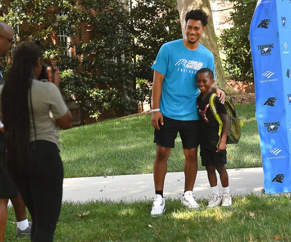 Panthers quarterback Bryce Young takes a photo with Aidan Davis, 7, of Charlotte, on the first day of training camp at Wofford College, July 25, 2023.