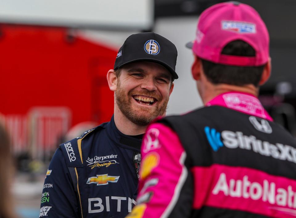 Conor Daly of Ed Carpenter Racing laughs with Simon Pagenaud of Meyer Shank Racing in the paddock during day two of NTT IndyCar Series open testing at The Thermal Club in Thermal, Calif., Friday, Feb. 3, 2023. 