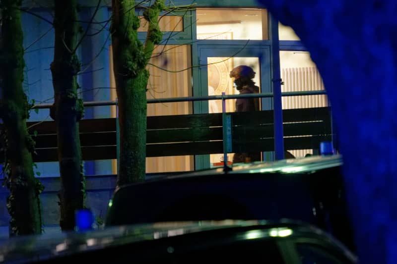 A heavily armed police officer is on duty at a hospital in Aachen, where a 65-year-old woman barricaded herself inside. Henning Kaiser/dpa