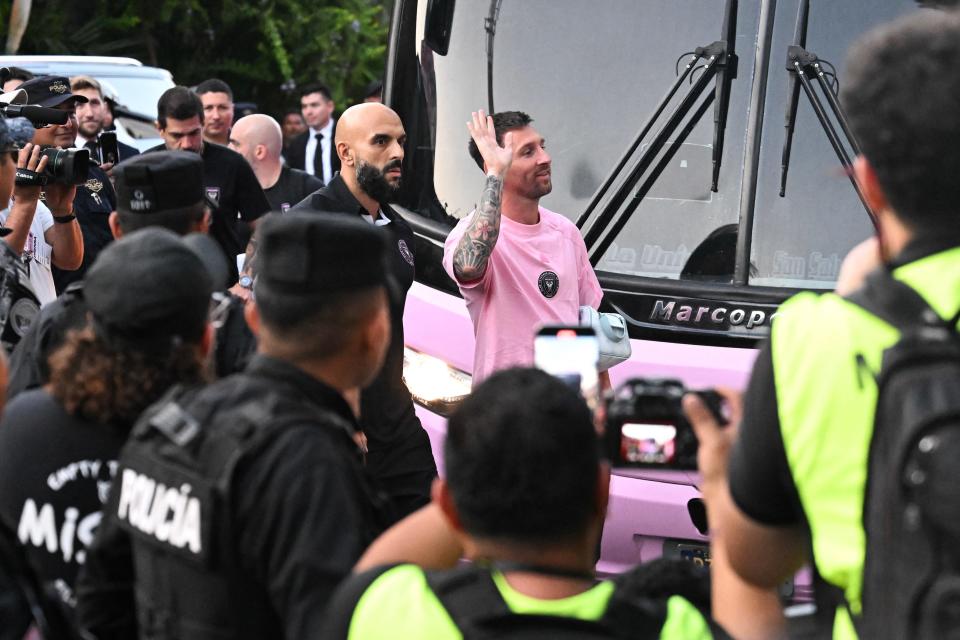 Lionel Messi waves to fans upon his arrival before the match against the El Salvador national team.