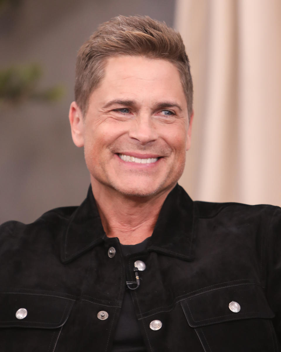 Headshot of a smiling, clean-shaven Rob