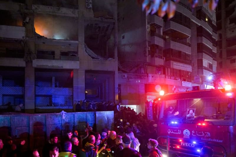 Lebanese firefighters gather around a building targeted in a blast, that resulted in killing Hamas deputy leader Saleh al-Arouri and six other people. The cause was initially unclear but reports quickly began to circulate suspecting that it could have been a targeted killing on behalf of Israel. Stringer/dpa