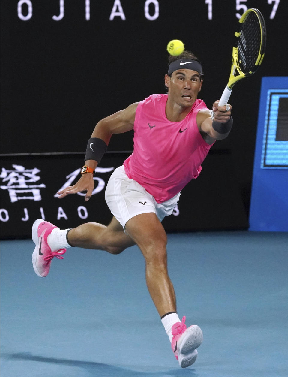 Spain's Rafael Nadal makes a forehand return to Australia's Nick Kyrgios during their fourth round singles match at the Australian Open tennis championship in Melbourne, Australia, Monday, Jan. 27, 2020. (AP Photo/Lee Jin-man)