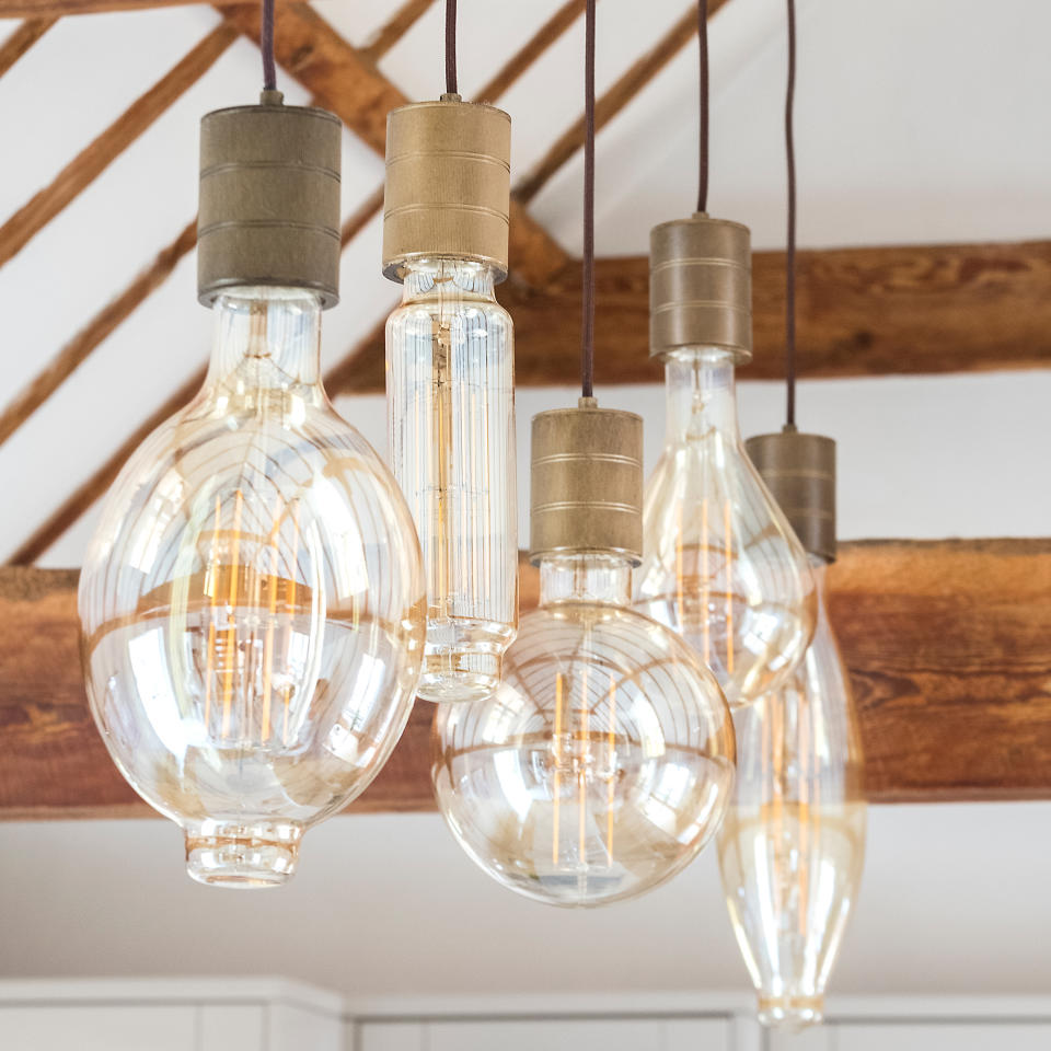 Close up of three pendant lights with differently shaped glass shades