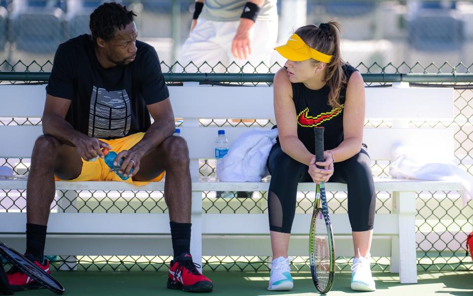 Elina Svitolina of Ukraine talks to husband Gael Monfils of France during a practice break at the 2022 BNP Paribas Open at the Indian Wells Tennis Garde - Robert Prange/Getty Images