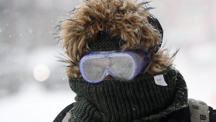 A woman wearing goggles walks through the snow on January 4, 2018, in Brooklyn, New York.