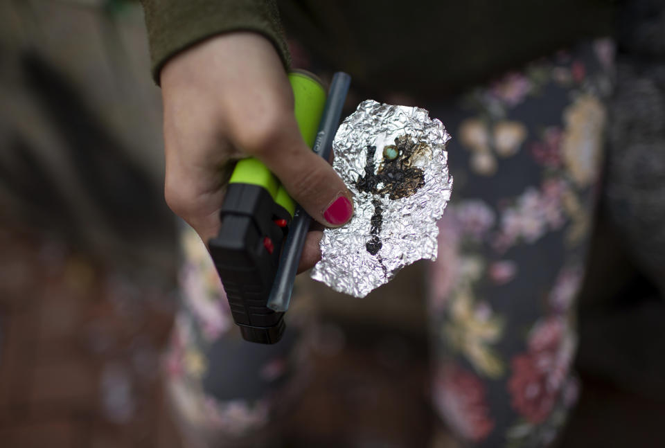 FILE - A person holds drug paraphernalia near the Washington Center building on SW Washington Street, April 4, 2023, in downtown Portland, Ore. A bill recriminalizing the possession of small amounts of drugs was passed by the Oregon Legislature, Friday, March 1, 2024, undoing a key part of the state’s first-in-the-nation drug decriminalization law as governments struggle to respond to the deadliest overdose crisis in U.S. history. (Dave Killen/The Oregonian via AP, File)