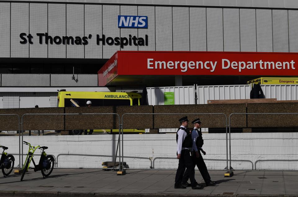 British police officers stand on duty outside St Thomas' Hospital in central London, where Britain's Prime Minister Boris Johnson is in intensive care on April 7, 2020. - British Prime Minister Boris Johnson spent the night in intensive care after being admitted with a deteriorating case of coronavirus, prompting serious concerns on Tuesday about his health and the government's response to a still-escalating outbreak. Johnson asked Foreign Secretary Dominic Raab to deputise for him shortly before he was moved to the intensive care unit of a London hospital on Monday evening. (Photo by DANIEL LEAL-OLIVAS / AFP) (Photo by DANIEL LEAL-OLIVAS/AFP via Getty Images)