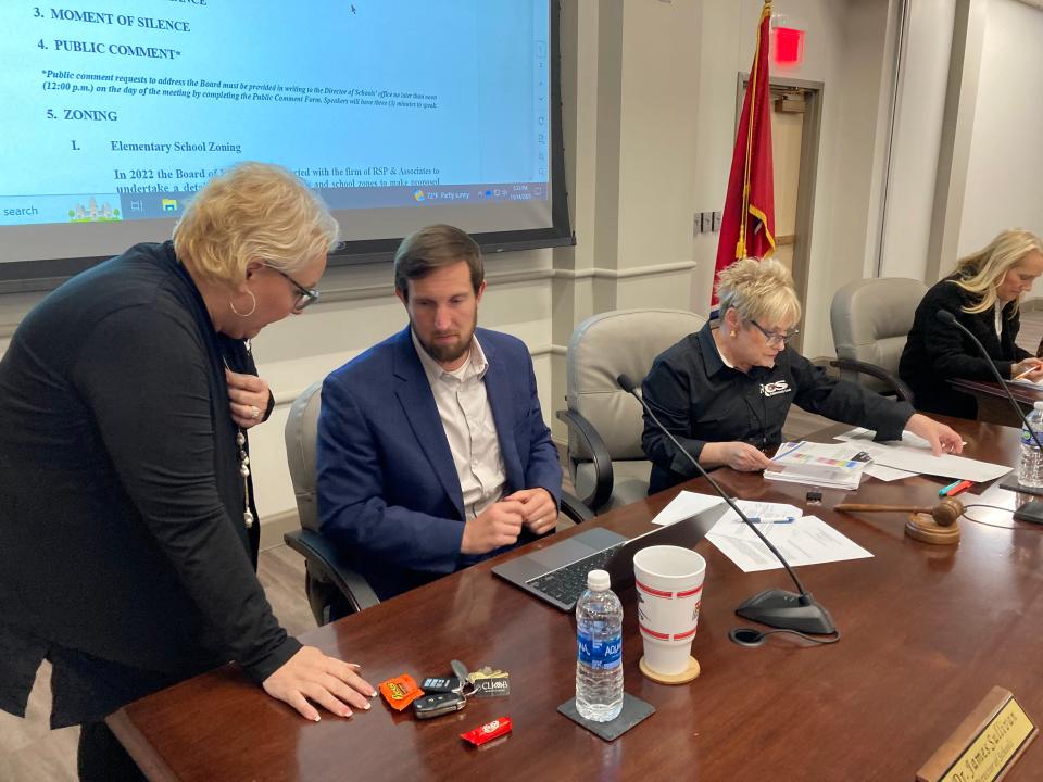 Rutherford County Board of Education member Tammy Sharp, left, speaks with Schools Director James "Jimmy" Sullivan Tuesday, Nov. 14, 2023, while chairwoman Shelia Bratton and vice chairwoman Claire Maxwell examine documents prior to the start of a meeting to vote on districtwide rezoning of schools.