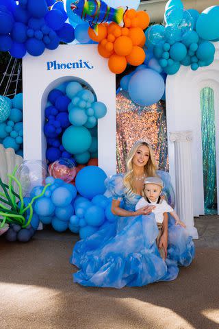 <p>Kevin Ostajewski</p> Paris Hilton and Phoenix pose at "Sliving Under the Sea" first birthday party