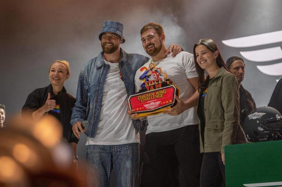 Travis Kelce puts his arm around Ryan Gillum, who won the Wingstop Chicken Wing Challenge.