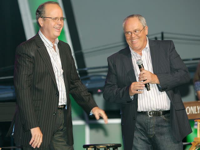 <p>Ethan Miller/Getty</p> Virl Osmond and Tom Osmond speak during a meet and greet with fans in 2007