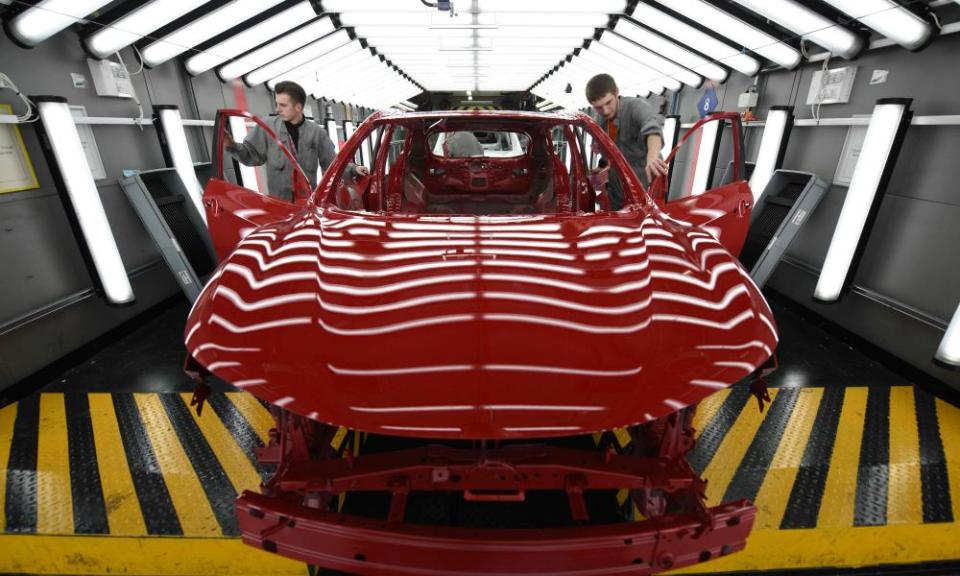 Nissan workers inspect a Qashqai model at the firm’s Sunderland plant