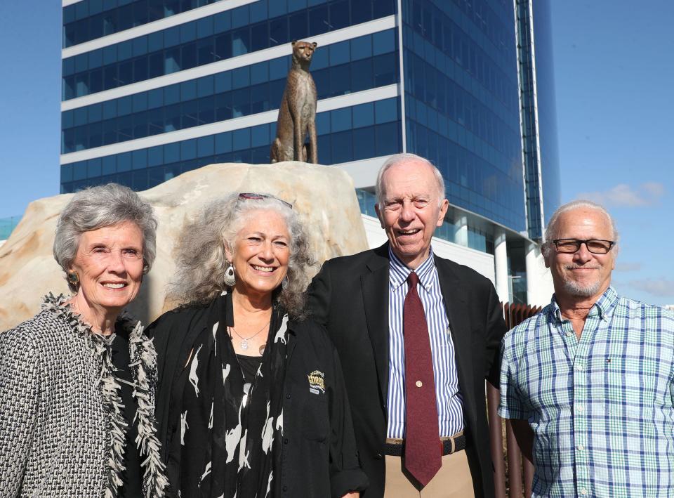 Dr. Laurie Marker, second from the left, founder of the Cheetah Conservation Fund, stands in front of the bronze cheetah sculpture in front of the headquarters for Brown & Brown Insurance at 300 N. Beach St., Daytona Beach on Monday, Oct. 30, 2023. Also pictured: Cici Brown, left, her husband J. Hyatt Brown (Brown & Brown's chairman), second from the right, and the sculpture's artist Paul Baliker.