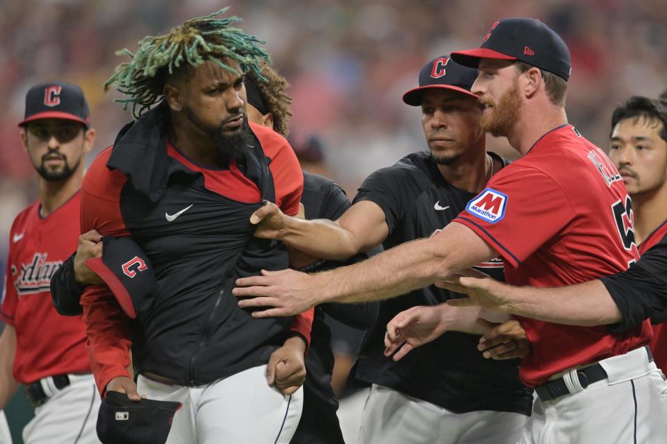 Aug 5, 2023; Cleveland, Ohio, USA; Teammates restrain Cleveland Guardians relief pitcher Emmanuel Clase (48) after a fight during the sixth inning at Progressive Field. Mandatory Credit: Ken Blaze-USA TODAY Sports