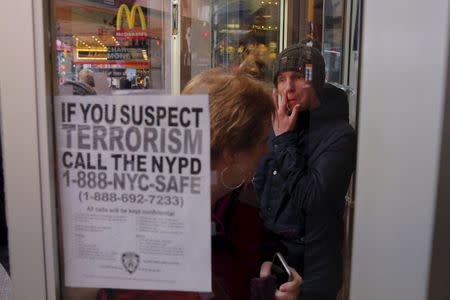 A sign asking for the public's help in stopping terrorism is posted on the window of a McDonalds outlet in the Times Square area of New York December 31, 2015. REUTERS/Lucas Jackson